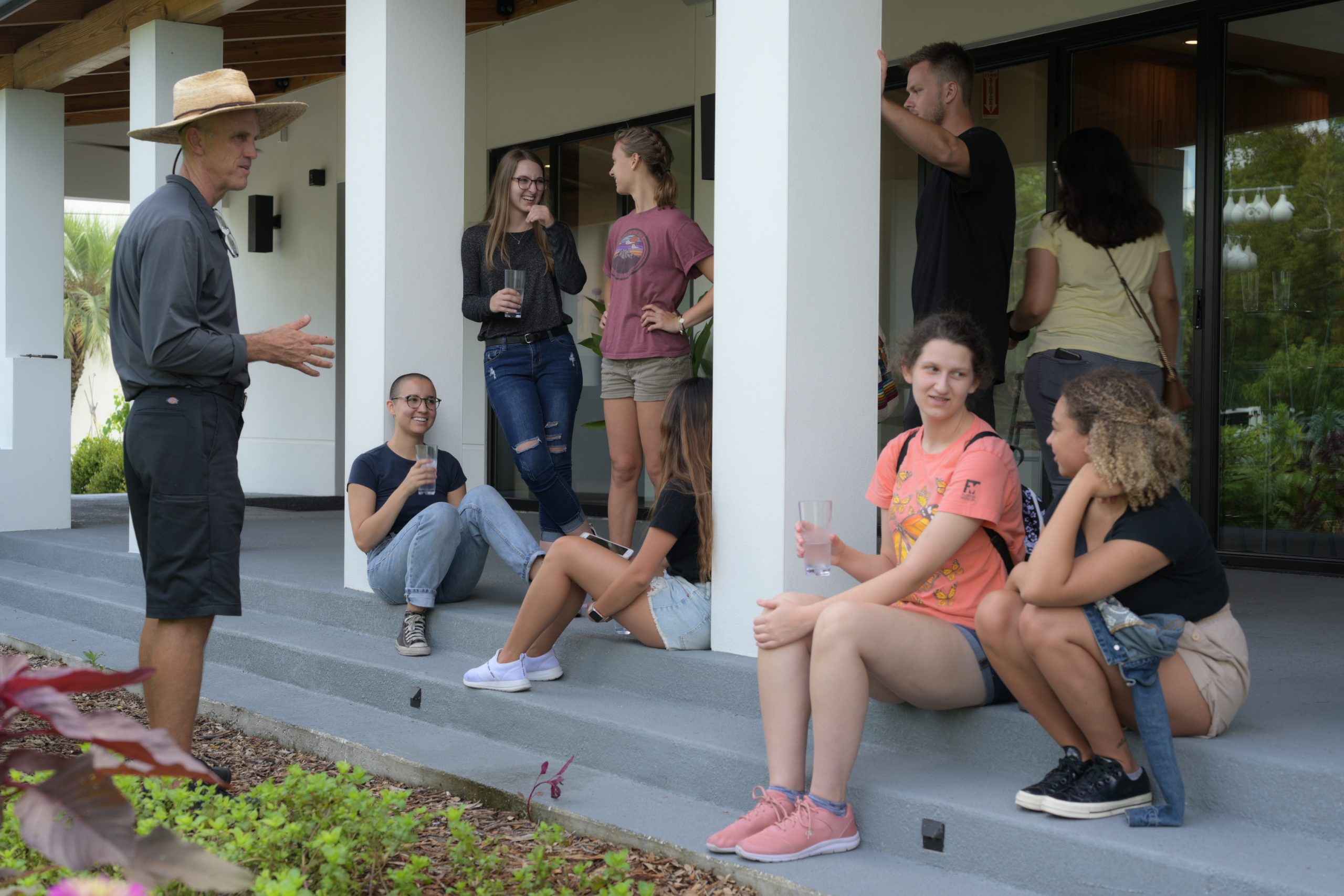 SBE students sit and talk on a porch at The Kitchen House in Orlando, FL.