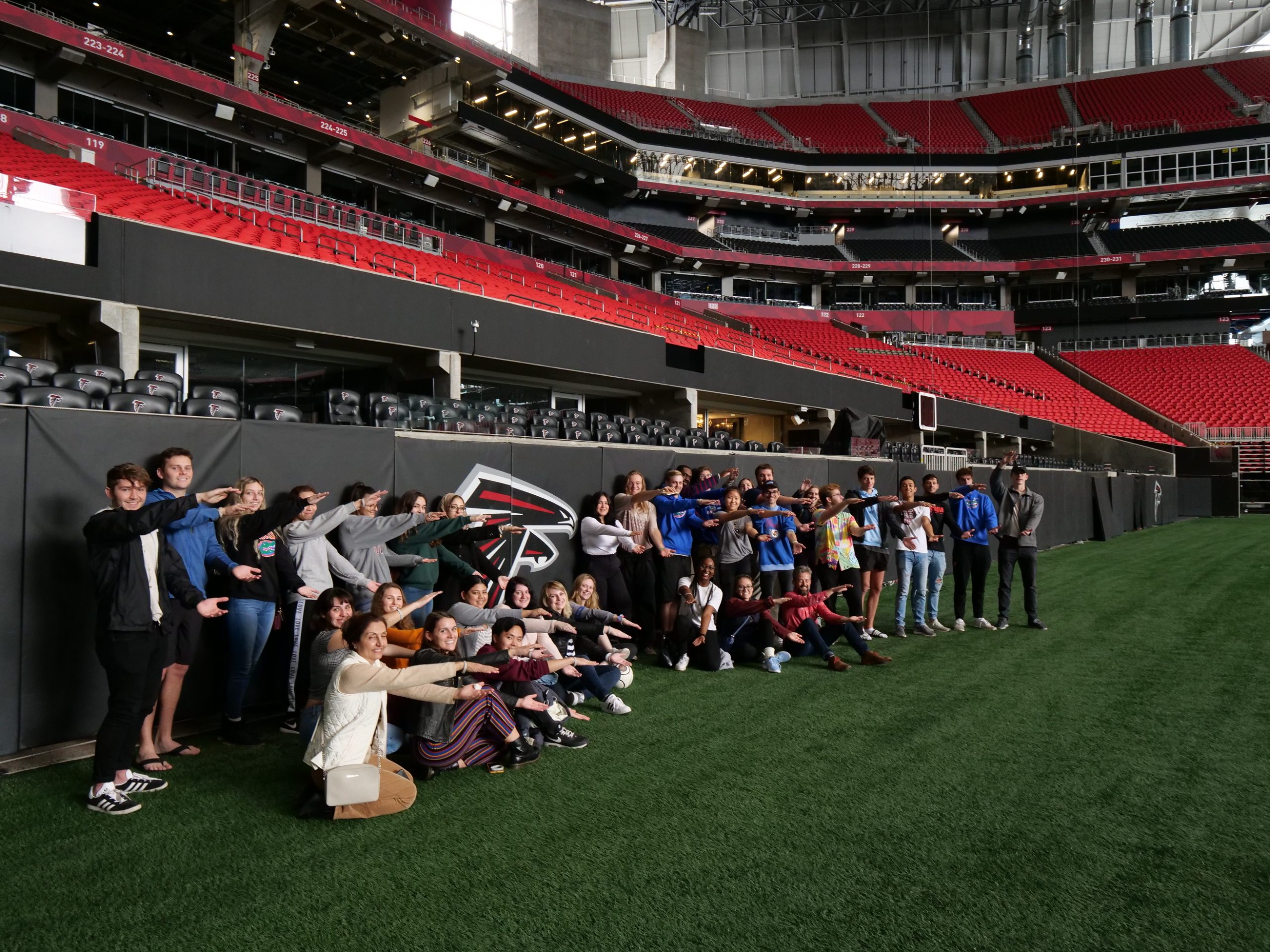 SBE students pose for a group photo on the field at Mercedes Benz Stadium in Atlanta, GA.