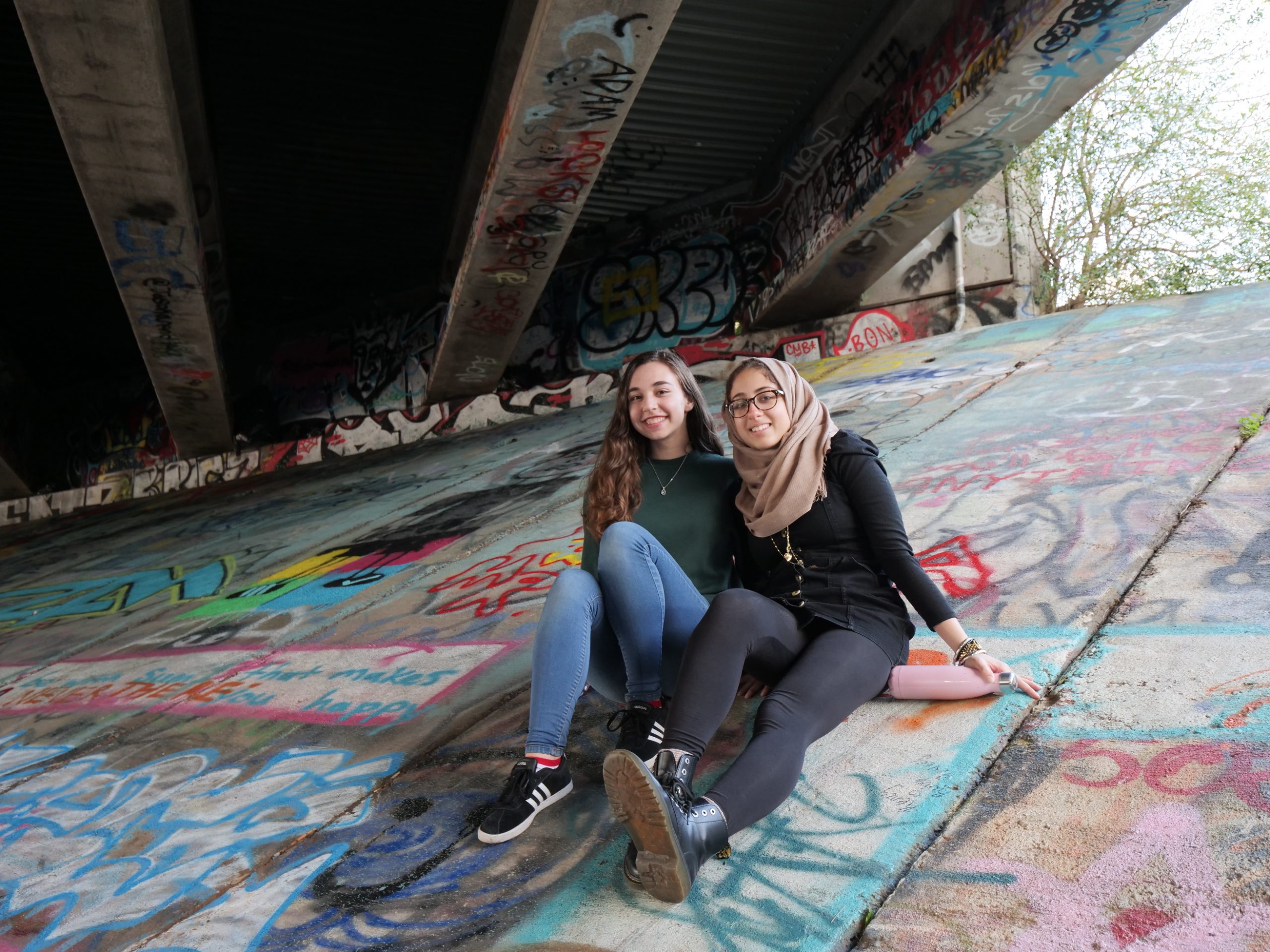 SBE students sit under a bridge amongst graffiti art along the Beltline in Atlanta, GA.