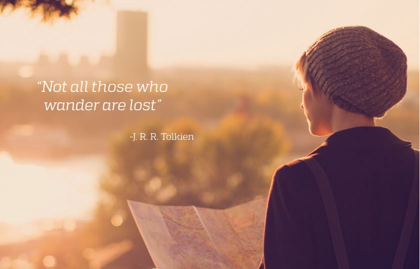 A person looking at a map in the sunset.