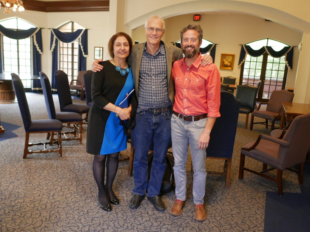 SBE faculty stand with a book author.