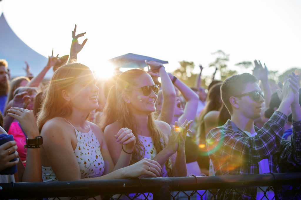 Students celebrate in the sunset.