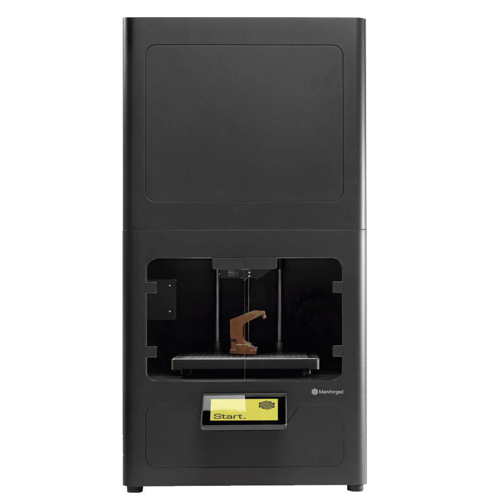 A black 3D printer with a visible brown object being printed inside and a yellow Start button on the front panel. The printer has a modern, boxy design.