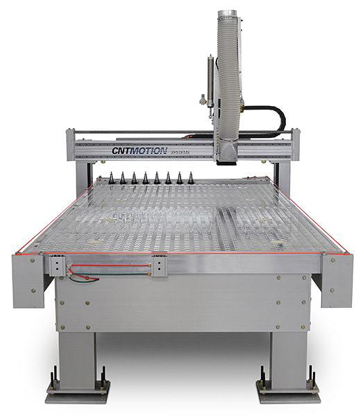 A large industrial CNC router machine with a metal work table, vertical routing head, and labeled CNCMOTION on the crossbar, designed for automated cutting or engraving of materials.